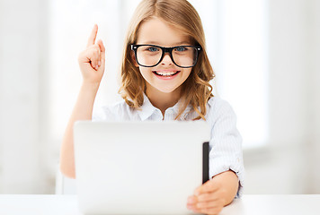 Image showing smiling girl in glasses with tablet pc at school