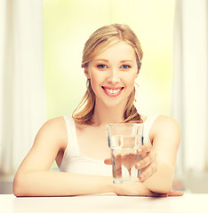 Image showing young smiling woman with glass of water