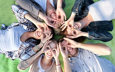 Image showing group of students or teenagers lying in circle