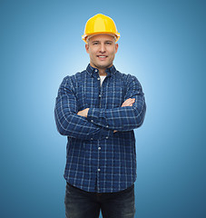 Image showing smiling male builder or manual worker in helmet