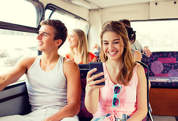 Image showing smiling couple with smartphone making selfie