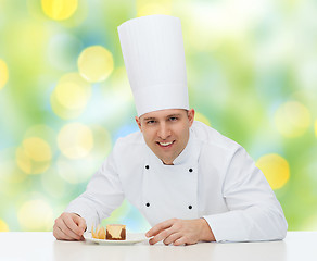 Image showing happy male chef cook decorating dessert