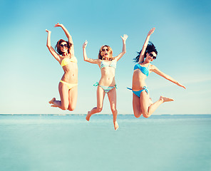 Image showing girls jumping on the beach