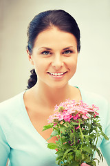 Image showing lovely housewife with flower