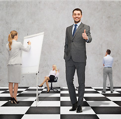 Image showing happy businessman showing thumbs up gesture