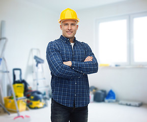 Image showing smiling male builder or manual worker in helmet