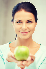 Image showing lovely housewife with green apple