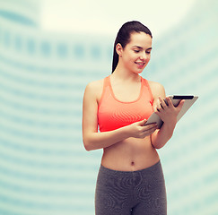 Image showing sporty woman with tablet pc computer