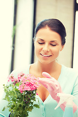 Image showing lovely housewife with flower