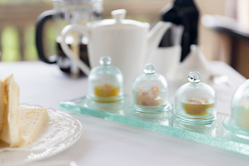 Image showing close up of tea time set with jam on table