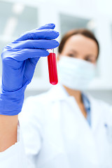 Image showing close up of scientist holding test tube in lab
