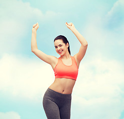 Image showing smiling teenage girl in sportswear dancing