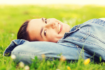 Image showing smiling young girl lying on grass