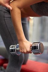 Image showing close up of couple with dumbbell exercising in gym