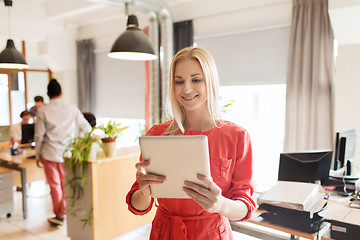 Image showing happy creative female office worker with tablet pc