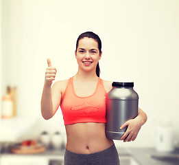 Image showing teenage girl with jar of protein showing thumbs up