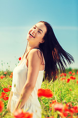 Image showing laughing young woman on poppy field