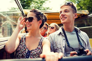 Image showing smiling couple with camera traveling by tour bus