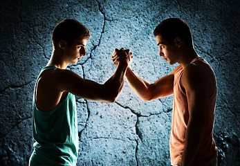 Image showing two young men arm wrestling