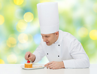 Image showing happy male chef cook decorating dessert