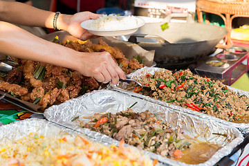 Image showing close up of hands with wok at street market