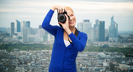 Image showing smiling woman taking picture with digital camera