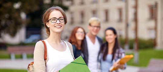 Image showing happy teenage students with school folders