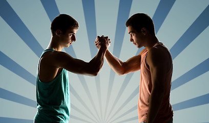 Image showing two young men arm wrestling