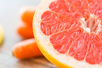 Image showing close up of fresh juicy grapefruit slice on table