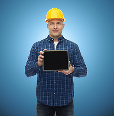 Image showing smiling male builder in helmet with tablet pc