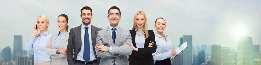 Image showing group of smiling businessmen over city background