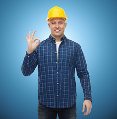 Image showing smiling male builder in helmet showing ok sign