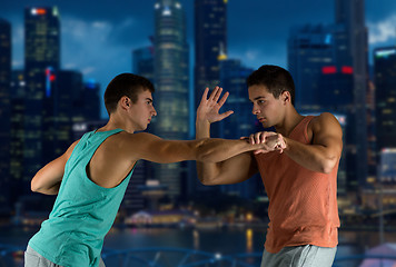 Image showing young men fighting hand-to-hand