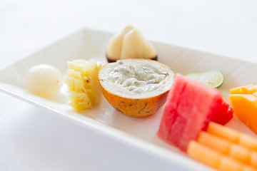 Image showing plate of fresh juicy fruit dessert at restaurant