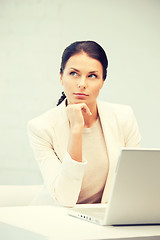 Image showing pensive woman with laptop computer