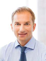 Image showing smiling businessman in office