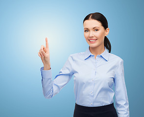 Image showing businesswoman touching something imaginary