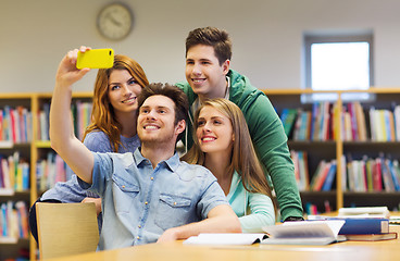 Image showing students with smartphone taking selfie in library