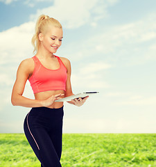 Image showing smiling sporty woman with tablet pc computer