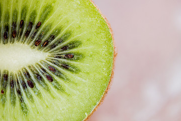 Image showing close up of ripe kiwi slice on table