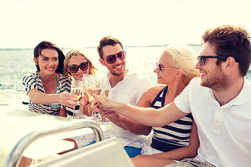 Image showing smiling friends with glasses of champagne on yacht