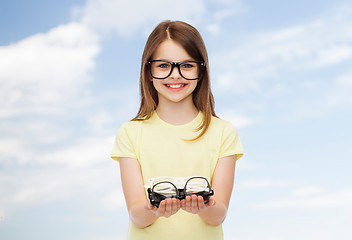 Image showing smiling cute little girl in black eyeglasses