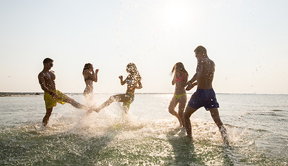 Image showing happy friends having fun on summer beach