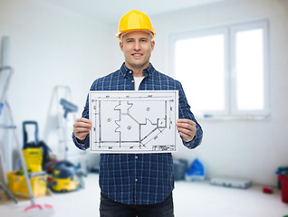 Image showing smiling male builder in helmet with blueprint