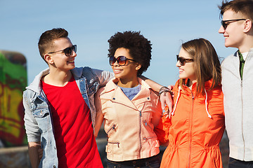 Image showing happy teenage friends in shades talking on street