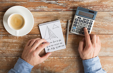 Image showing close up of hands with calculator solving task