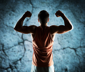 Image showing young man or bodybuilder showing biceps