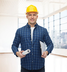 Image showing smiling male builder in helmet with blueprint