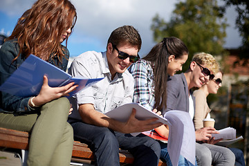 Image showing group of happy students with notebooks at campus