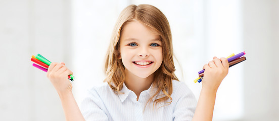 Image showing smiling girl showing colorful felt-tip pens